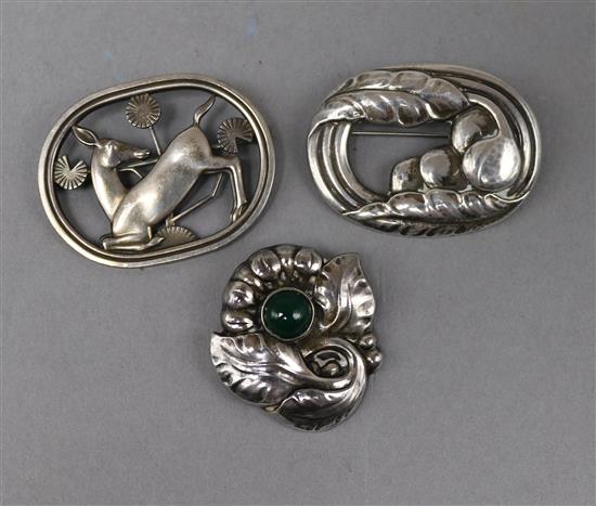 Three Georg Jensen brooches: a sterling deer brooch, model no.256, in Jensen box, a silver oval fruit brooch, model no.18,